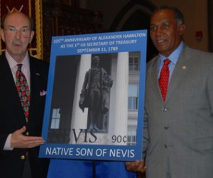 Premier of Nevis Vance Winkworth Amory unveils the stamp with John Herzog, founder of the The Museum of American Finance.