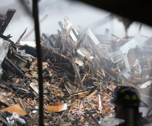 The grim search of the rubble on Park Ave. continued into Thursday, March 13, 2014. (Reuters image) 