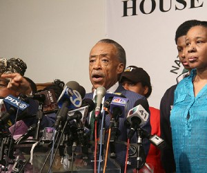  L to R., Gwen Carr, mother of Eric Garner, Reverend Al Sharpton, and Garner's son Emory addresses a press conference at the National Action Network headquarters after the grand jury returned an non indictment on Dec. 3, 2014. (Hakim Mutlaq image)