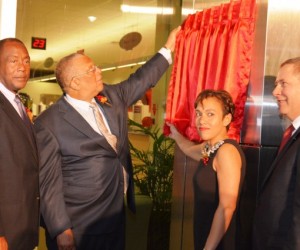 Minister of Finance and Planning, Dr. the Hon Peter Phillips (2nd left), is assisted by President and Chief Executive Officer of Scotia Group Jamaica Limited, Jacqueline Sharp, in unveiling the plaque commemorating the bank’s Fairview Financial Centre in Montego Bay, which was officially opened on Wednesday (January 7). Sharing the moment are Mayor of Montego Bay, His Worship, Councillor Glendon Harris (left); and Scotia Group’s Senior Vice President for English Caribbean International Banking, Bruce Bowen. Courtesy JIS Photographer