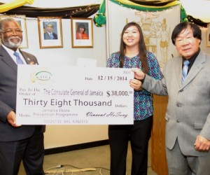 Consul General of Jamaica, Herman LaMont (left), receives donation of US$38,000 for the purchase of thermal sensing unit, from Sabrina HoSang and Vincent HoSang, Chairman of the Vincent HoSang Family Foundation (VHFF), at the Consulate in New York, on December 22. Photo Courtesy JIS Photographer