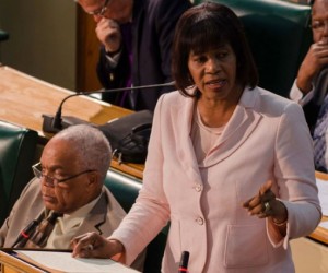 Prime Minister the Most Hon. Portia Simpson Miller speaking in the House of Representatives on January 20, as she closes debate on the Bills making the Caribbean Court of Justice (CCJ) the final court of appeal for Jamaica. Seated at left is Minister of Transport, Works and Housing, Dr. the Hon. Omar Davies