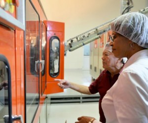 Prime Minister, the Most Hon. Portia Simpson Miller (right), and Founder and Executive Chairman, LASCO Affiliated Companies, Lascelles Chin, observe operations at LASCO Manufacturing Ltd’s liquid manufacturing plant in White Marl, St. Catherine, during a tour on January 14. Picture Courtesy JIS.