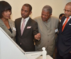 Photo by: JIS Photographer. Mr. Rodney Leon (second left), winner of the design competition, ‘The Ark of Return’, to be erected as a Permanent Memorial to the victims of slavery and the transatlantic slave trade at the United Nations (UN) Headquarters in New York, explains his concept to (from left), Prime Minister, the Most Hon. Portia Simpson Miller; Antiguan Prime Minister, Hon. Baldwin Spencer and Jamaica's Permanent Representative to the United Nations, Ambassador Courtenay Rattray, at on September 23 unveiling at the UN. 