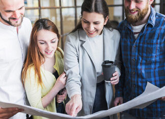 happy-coworkers-working-blue-print-office