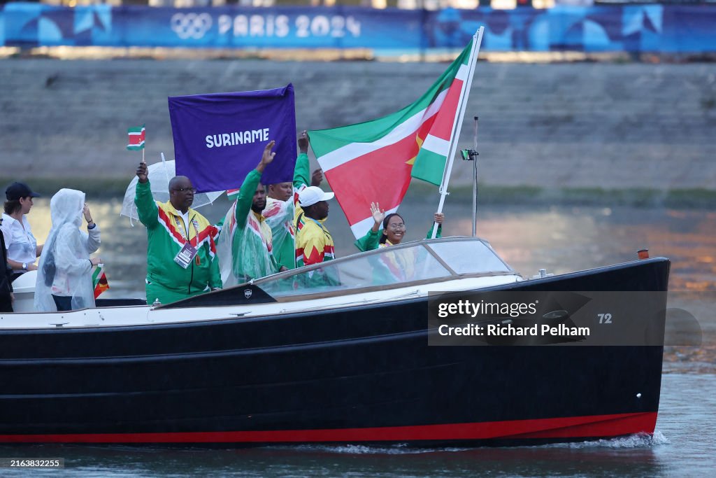 Team Suriname are seen on a boat waving their flag along the River Seine during the opening ceremony of the Olympic Games Paris 2024 on July 26, 2024 in Paris, France.