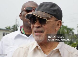 Suriname's former president (2010-2020) Desi Bouterse walks next to a body guard while leaving the High Court of Justice after a hearing in his appeals case in the December 8, 1982 murders, in Paramaribo on January 31, 2023. - Suriname's public prosecutor's office reaffirmed its request for a 20-year prison sentence for Bouterse if the sentence against him for the execution of 15 opponents in 1982 is upheld. Attorney General Carmen Rasam also formally requested Bouterse's imprisonment if the sentence is confirmed. (Photo by Ranu Abhelakh / AFP) (Photo by RANU ABHELAKH/AFP via Getty Images)